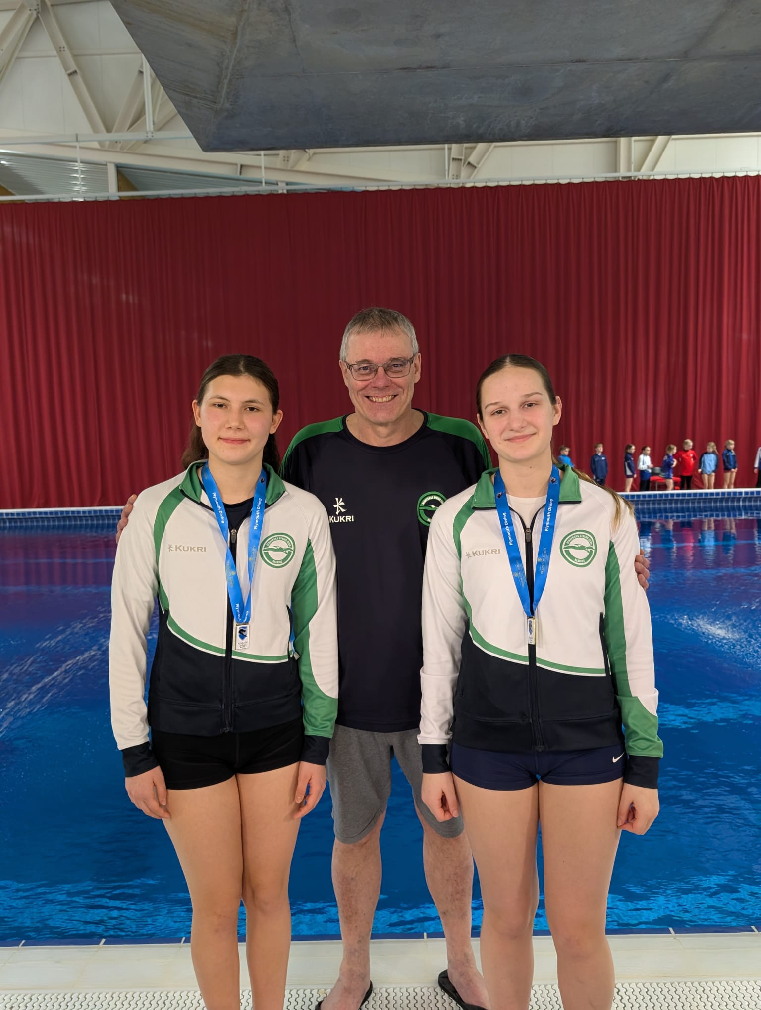 Head coach Malcolm Green with Ariana and Naya after their podium finishes on 3m